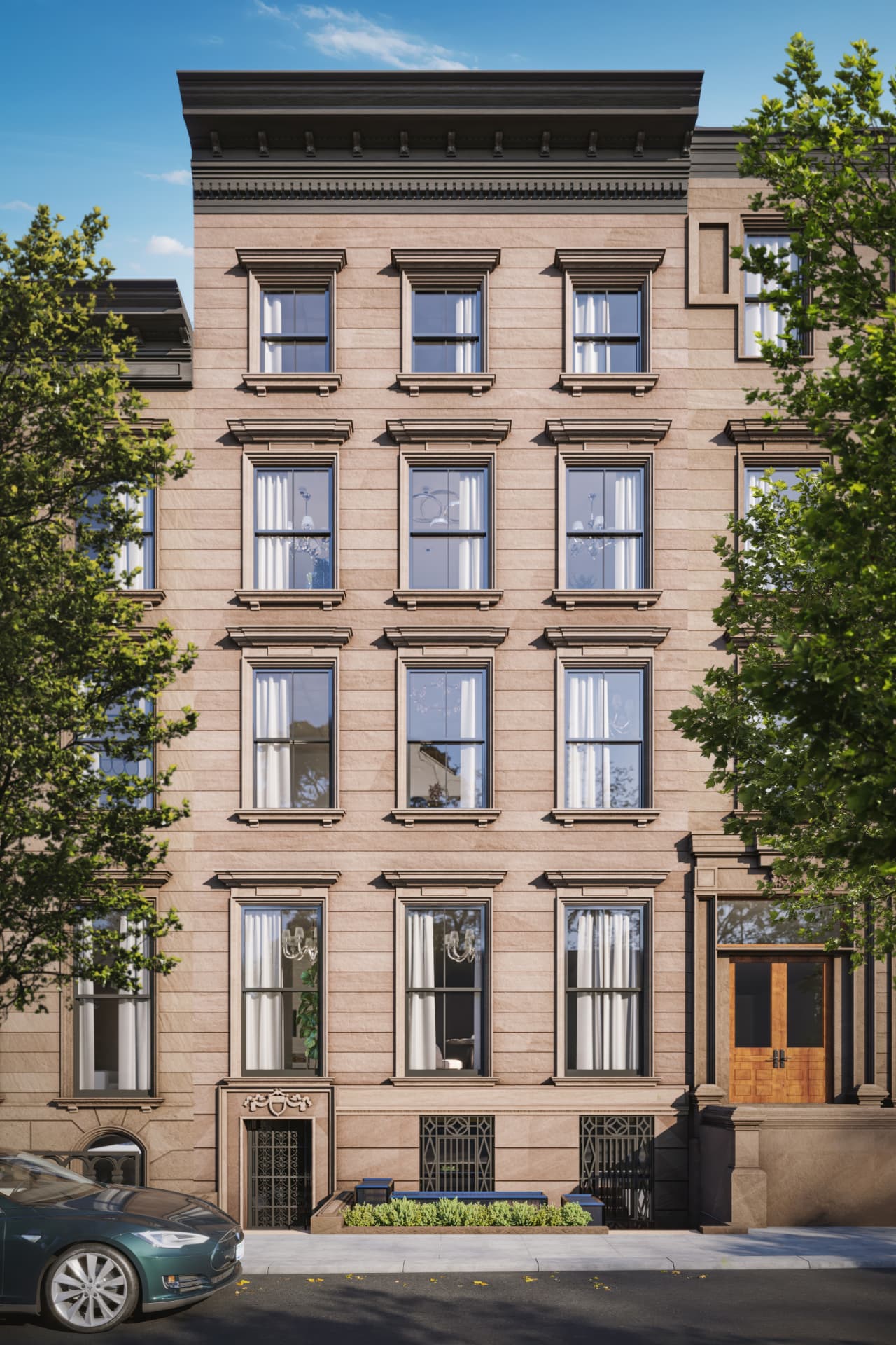 The restored 1855 facade of 138 Joralemon Street with carved cornices and arched entry