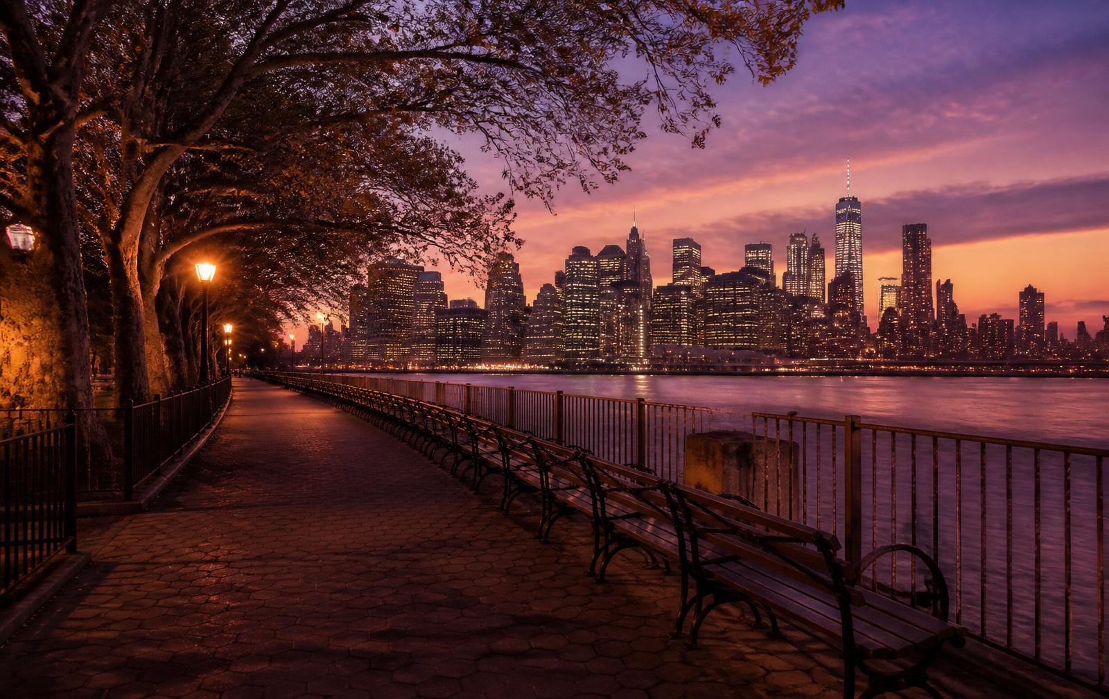 The Brooklyn Heights Promenade at dusk with the Manhattan skyline beyond